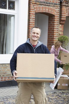 Professional moving team in Soho packing boxes.